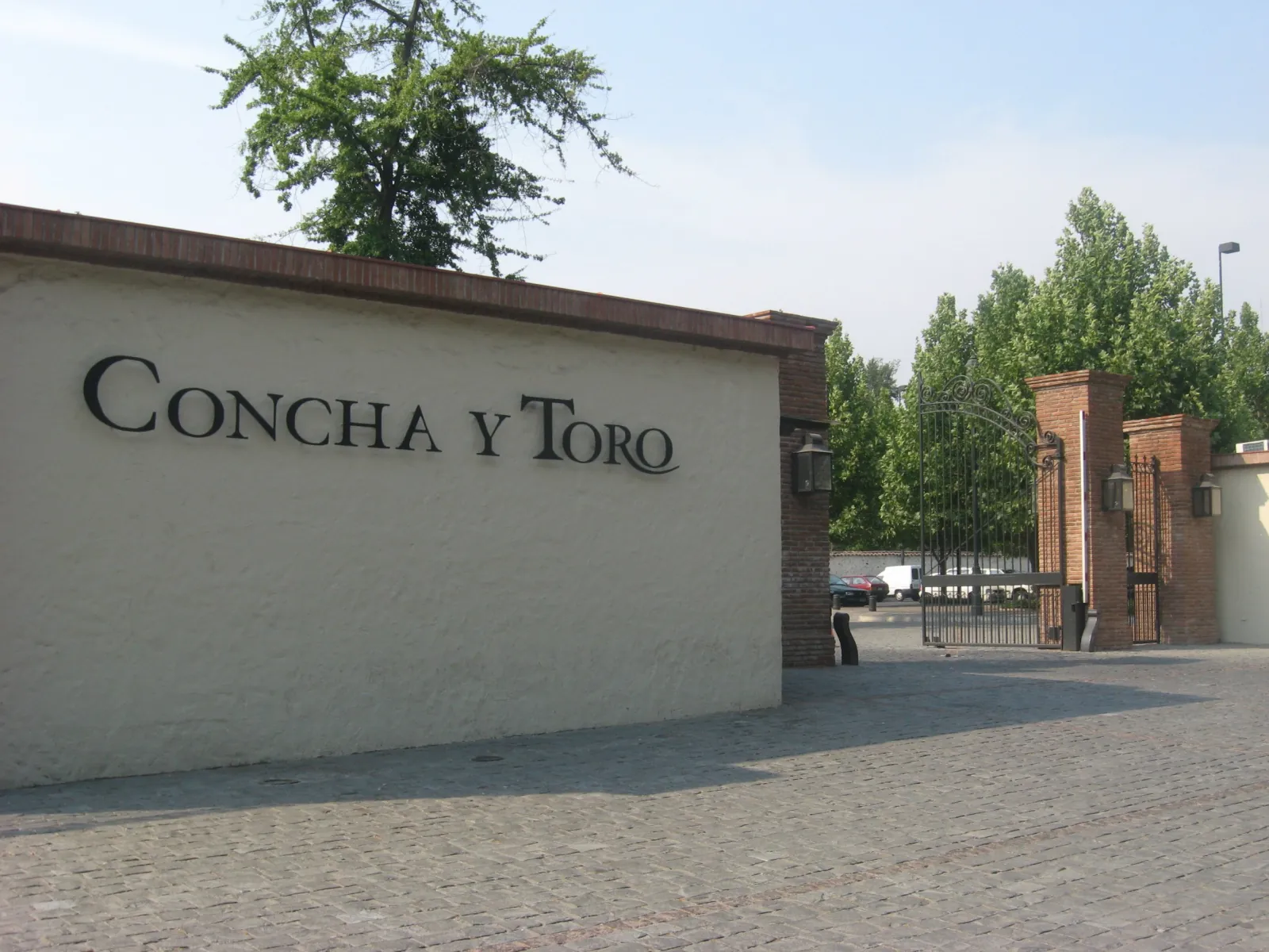 Concha y Toro name on a cream wall next to an iron entrance gate