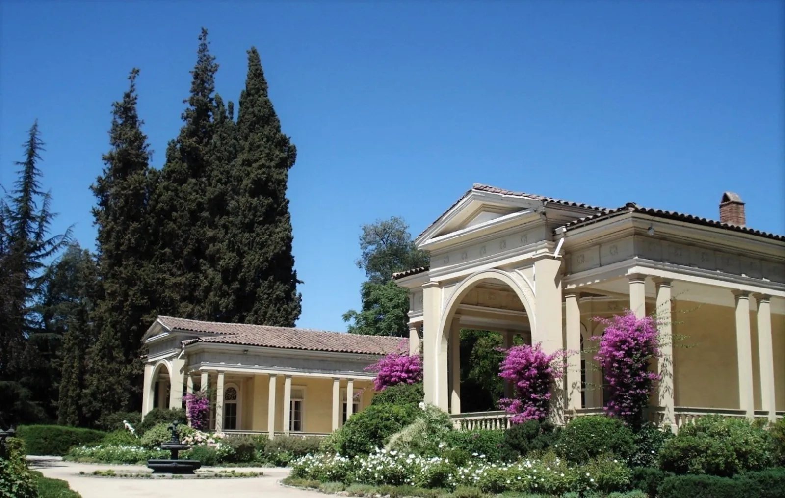 Columned Concha y Toro family house with pink bougainvillea and cypresses