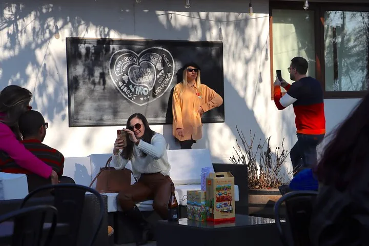 Guests photographing each other by an Undurraga chalkboard heart mural