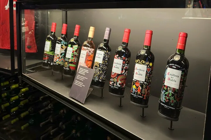 Decorated Casillero del Diablo bottles lined up in a display case